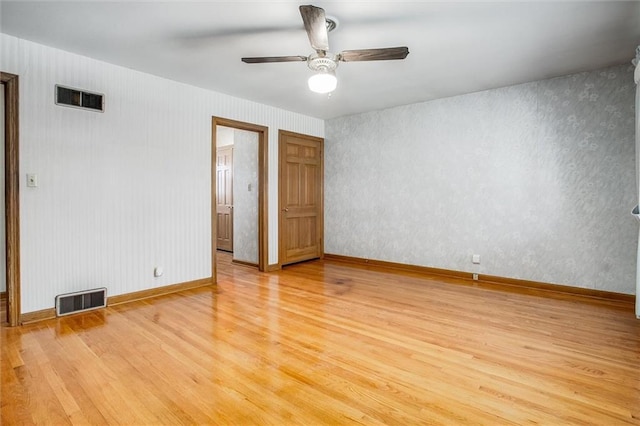 spare room featuring light hardwood / wood-style floors and ceiling fan