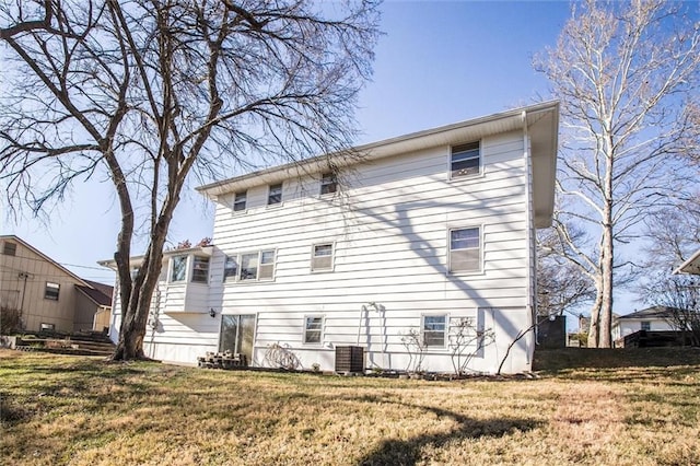 rear view of house featuring a yard