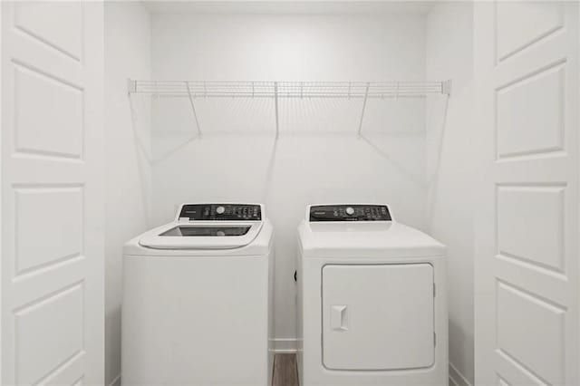 clothes washing area with separate washer and dryer