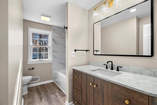 bathroom featuring hardwood / wood-style flooring, vanity, and toilet