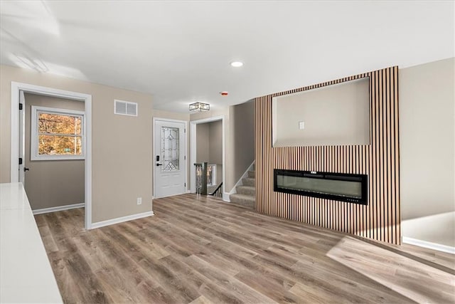 unfurnished living room with light hardwood / wood-style floors