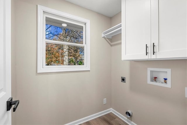 clothes washing area featuring cabinets, hookup for a washing machine, hardwood / wood-style flooring, and electric dryer hookup