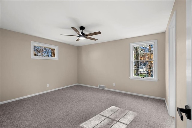 unfurnished room featuring light colored carpet and ceiling fan