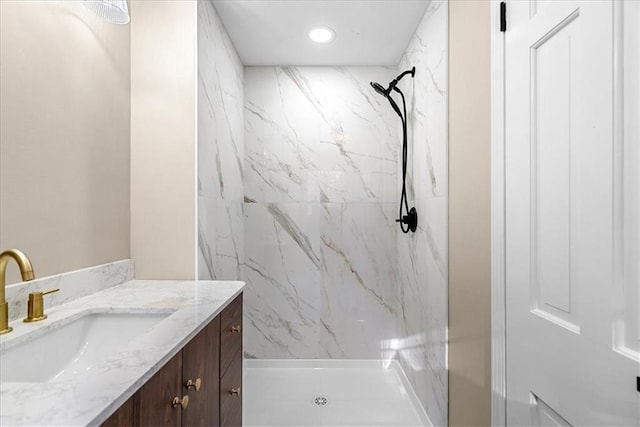 bathroom with vanity and tiled shower