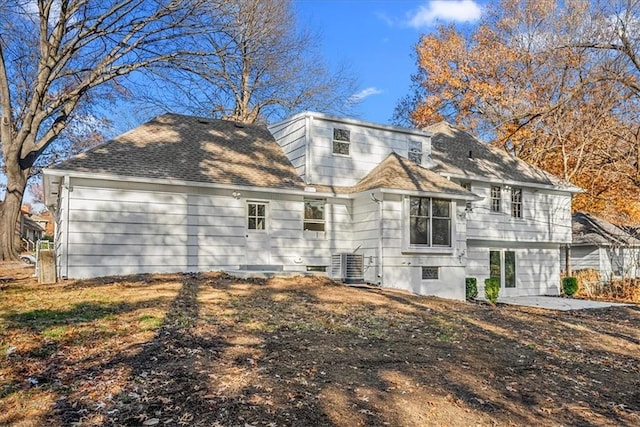 rear view of house with central AC and a patio area