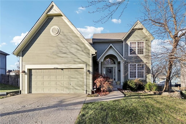 view of property with a garage and a front lawn