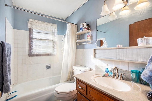 full bathroom with vanity, toilet, tile walls, and shower / tub combo with curtain