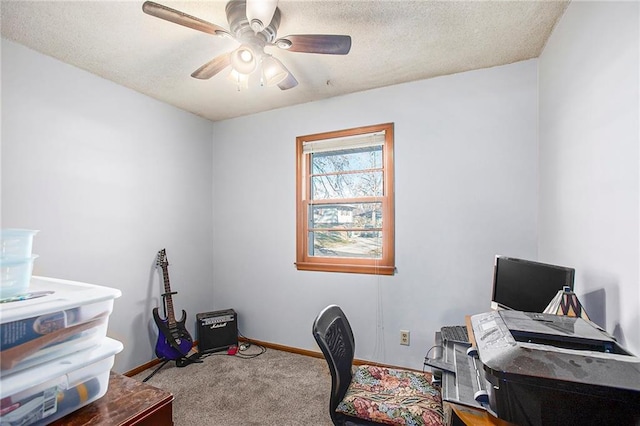 carpeted office featuring ceiling fan and a textured ceiling