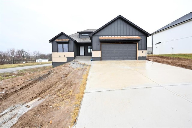 view of front of home with an attached garage, driveway, and board and batten siding