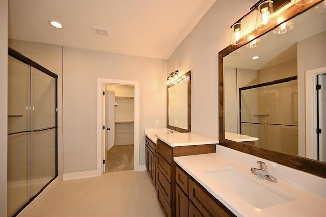 bathroom featuring a sink, visible vents, and a stall shower