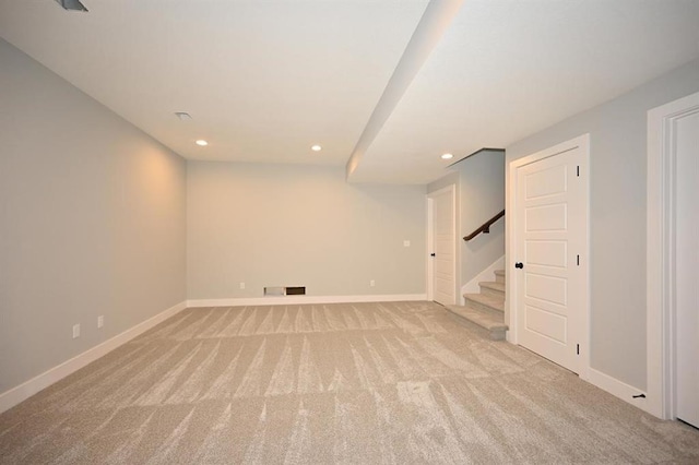 finished below grade area featuring recessed lighting, stairway, light carpet, and baseboards