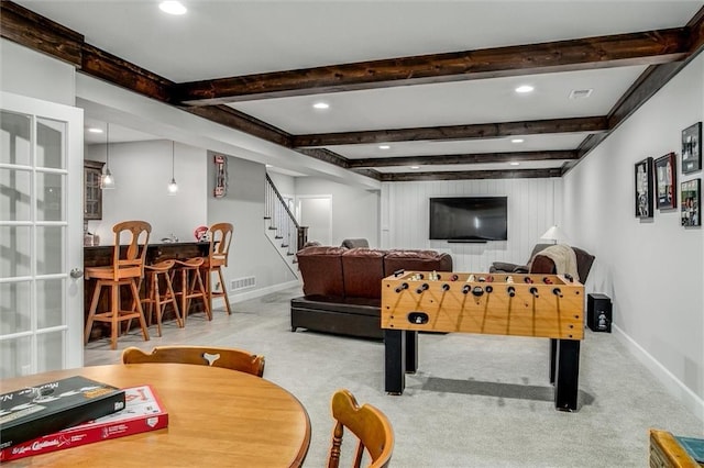 recreation room with beam ceiling and light carpet