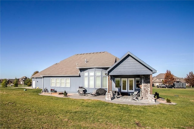 rear view of house with a yard and a patio area