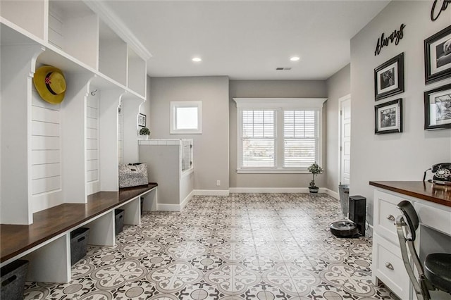 mudroom with a wealth of natural light and light tile patterned floors