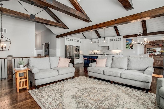 living room with beam ceiling, sink, dark wood-type flooring, high vaulted ceiling, and a notable chandelier