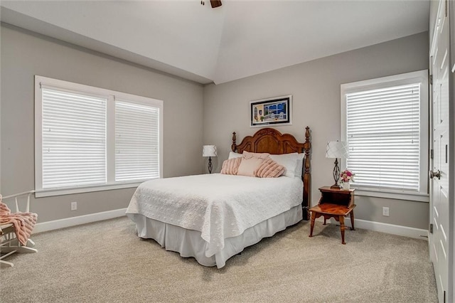 bedroom with light carpet, vaulted ceiling, and ceiling fan