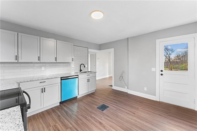 kitchen featuring sink, stainless steel dishwasher, electric range, dark hardwood / wood-style flooring, and white cabinetry