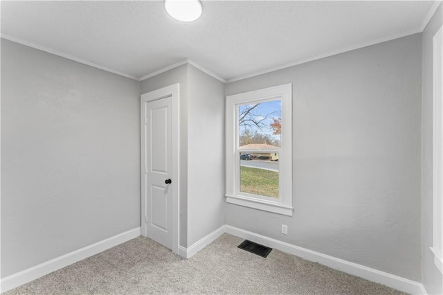 carpeted empty room with ornamental molding