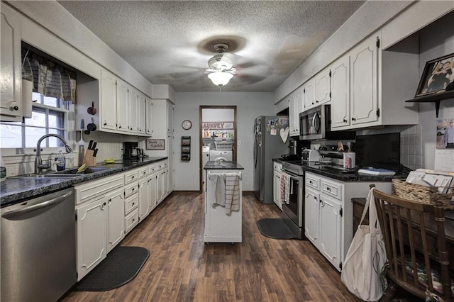 kitchen featuring sink, white cabinets, dark wood-type flooring, and appliances with stainless steel finishes