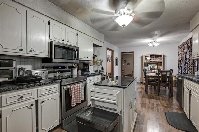 kitchen with white cabinetry, stainless steel appliances, tasteful backsplash, dark hardwood / wood-style flooring, and a textured ceiling