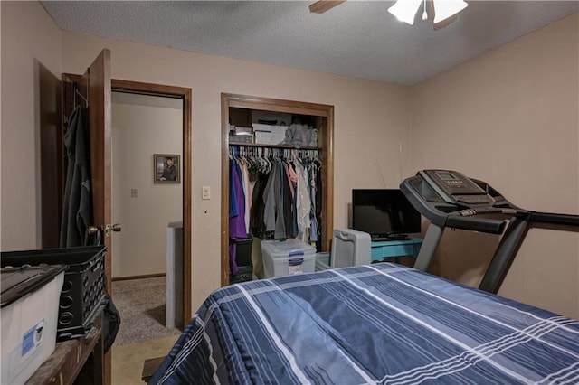 bedroom with ceiling fan, carpet floors, and a textured ceiling