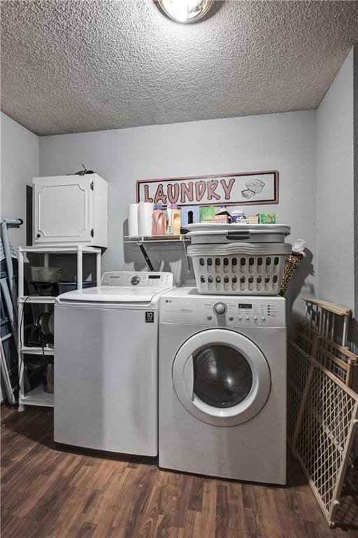 clothes washing area featuring dark hardwood / wood-style flooring, cabinets, independent washer and dryer, and a textured ceiling