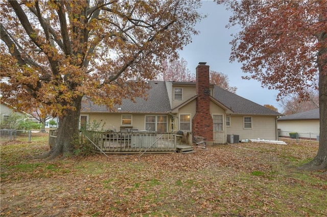 rear view of house with central air condition unit and a wooden deck