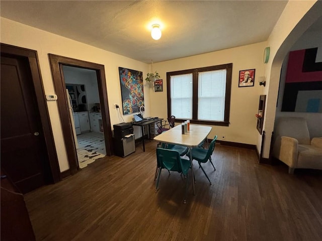 dining area featuring dark wood-type flooring