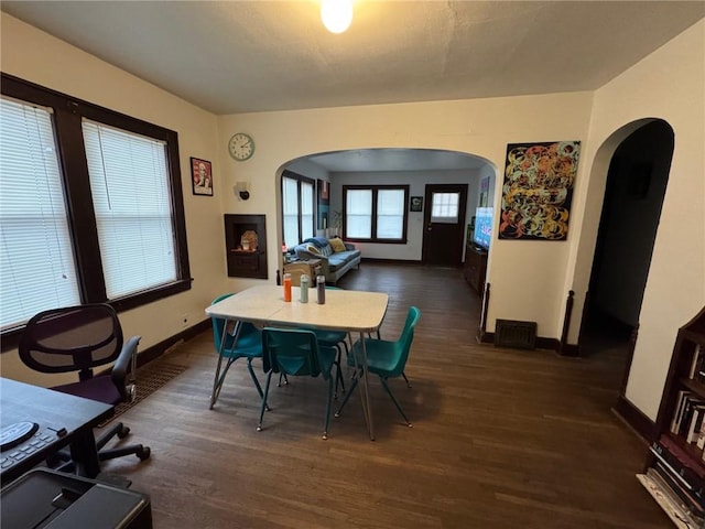 dining area with dark hardwood / wood-style flooring