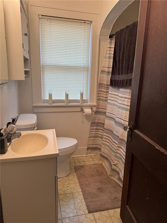 bathroom with tile patterned floors, vanity, and toilet