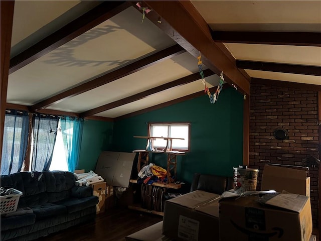 living room with lofted ceiling with beams and wood finished floors