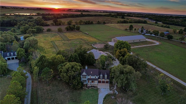 aerial view at dusk featuring a rural view