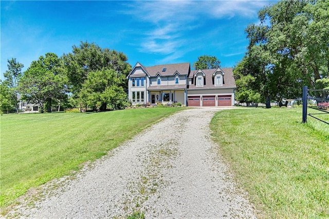 new england style home featuring a garage and a front lawn