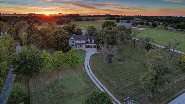 aerial view at dusk featuring a rural view