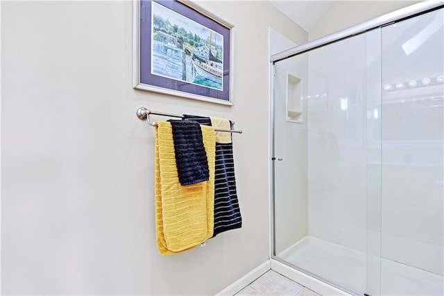 bathroom featuring a shower with shower door and tile patterned floors