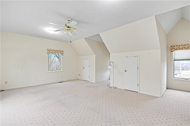 bonus room with lofted ceiling, light colored carpet, and ceiling fan