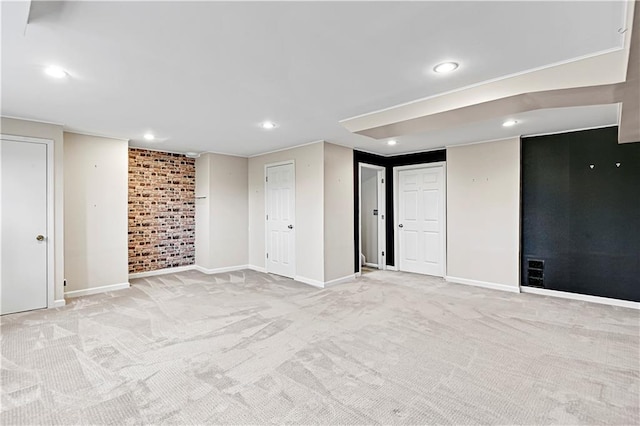 interior space with brick wall and light colored carpet