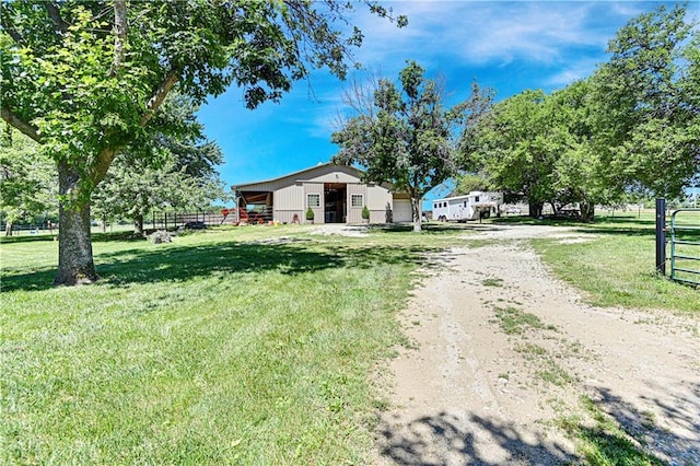 view of front of home featuring an outbuilding and a front lawn