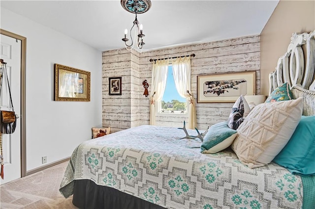 carpeted bedroom with an inviting chandelier