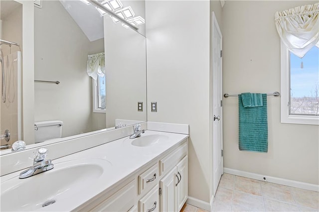 bathroom featuring tile patterned flooring, vanity, a shower, and toilet