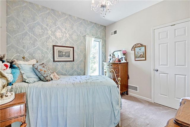 carpeted bedroom with an inviting chandelier