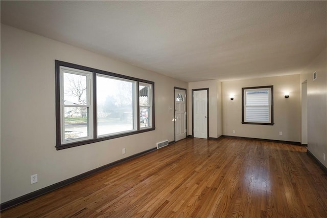 unfurnished room featuring dark hardwood / wood-style flooring