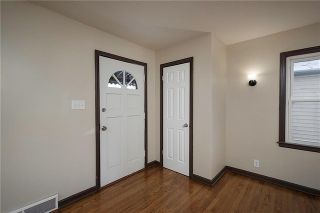 foyer entrance with dark hardwood / wood-style floors