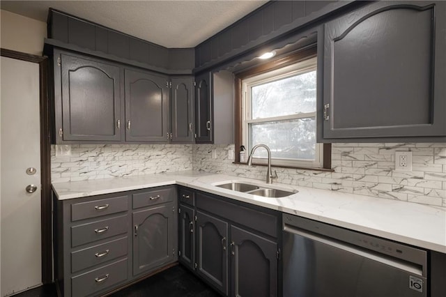 kitchen featuring stainless steel dishwasher, a textured ceiling, sink, and tasteful backsplash