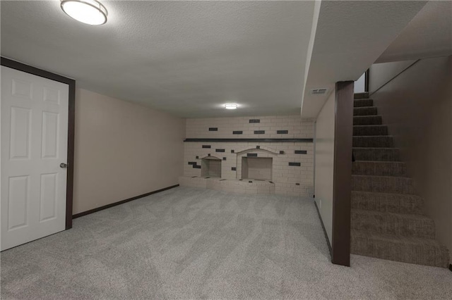 unfurnished living room featuring light colored carpet and a textured ceiling