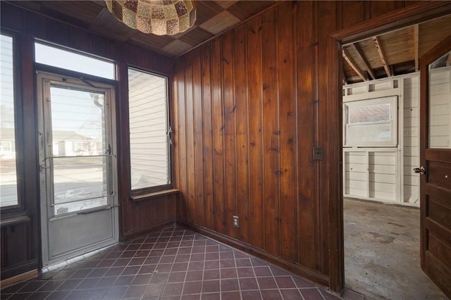 doorway to outside featuring wood walls