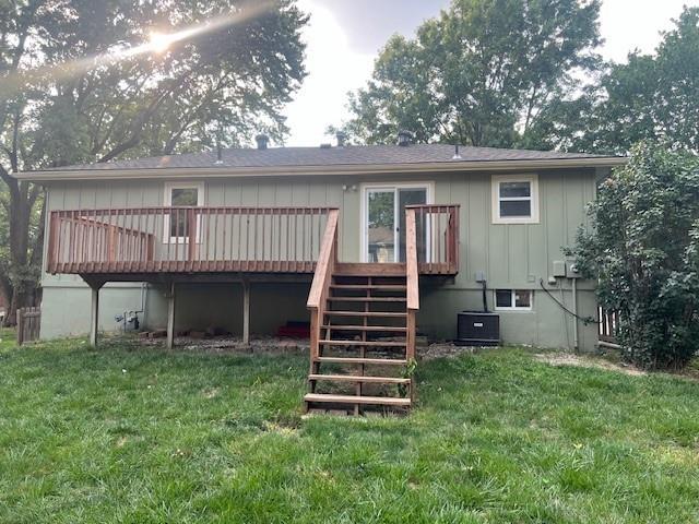 rear view of house with a lawn, central air condition unit, and a wooden deck