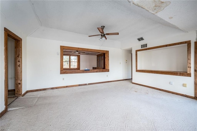 spare room with lofted ceiling, ceiling fan, and a textured ceiling