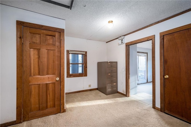 carpeted empty room featuring a textured ceiling