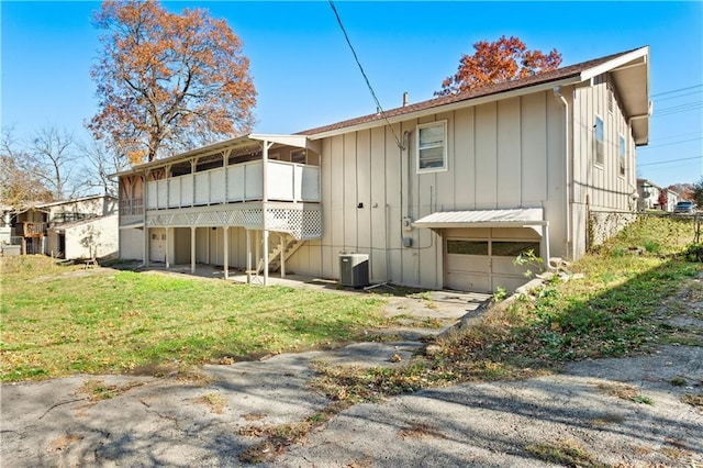 back of property featuring a yard and central AC unit